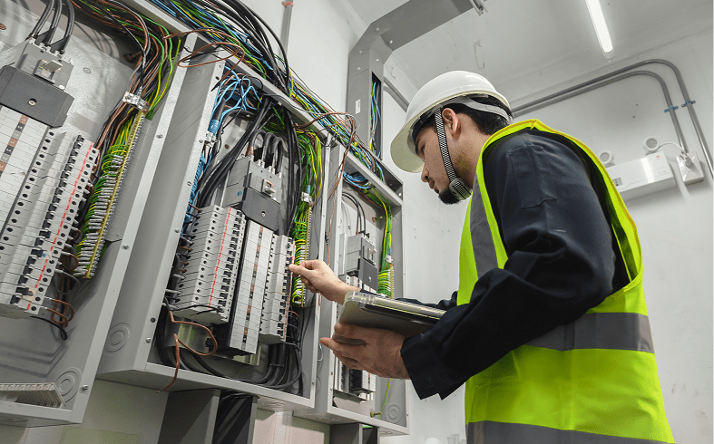 Technician checking wiring in control box