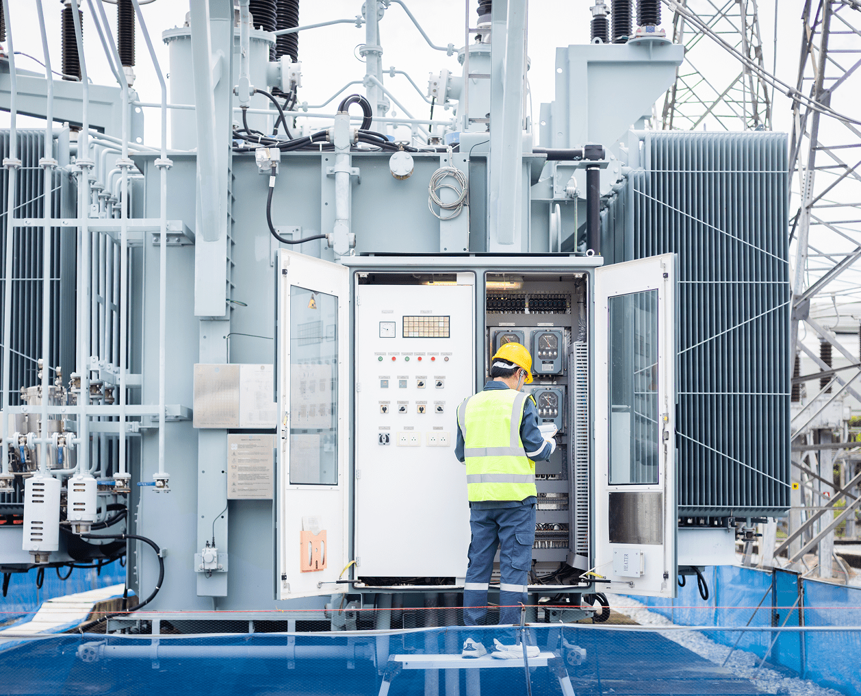 Technician checking control panel in substation