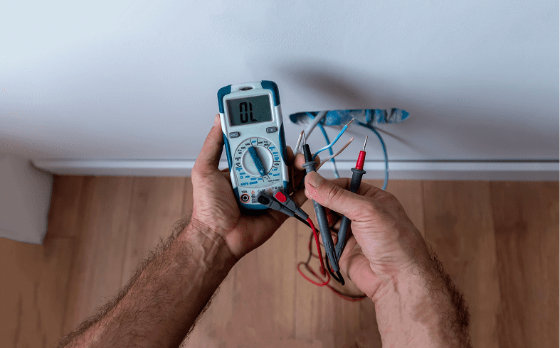 Person using a multimeter on wires